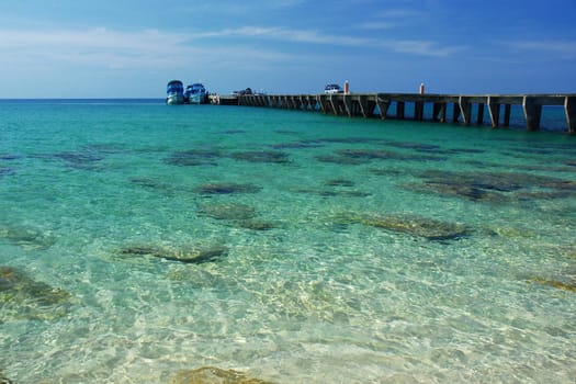 a local pier on island from Thailand with clear seawater
