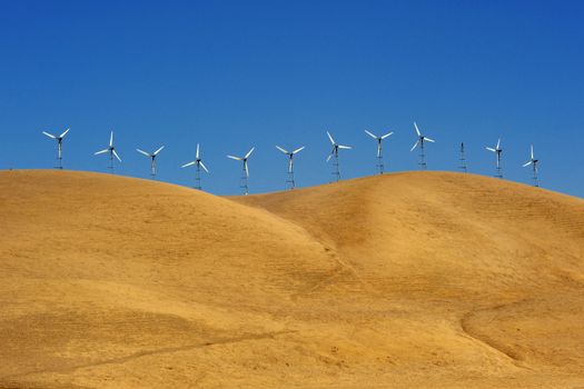 wind power generator on golden grass hill in california