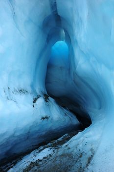 an entrance of Root Glacier ice cave, Alaska