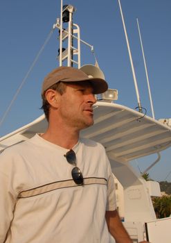 man with his casquett on a yacht boat


