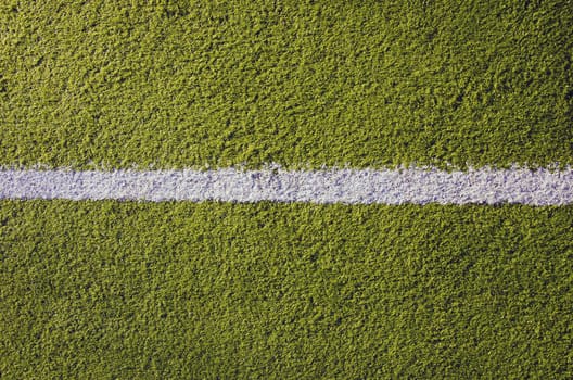 Synthetic sports pitches athletic green surface and white markings closeup background backdrop.