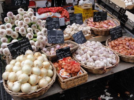 Photo of onions for sale at an outdoor market stall