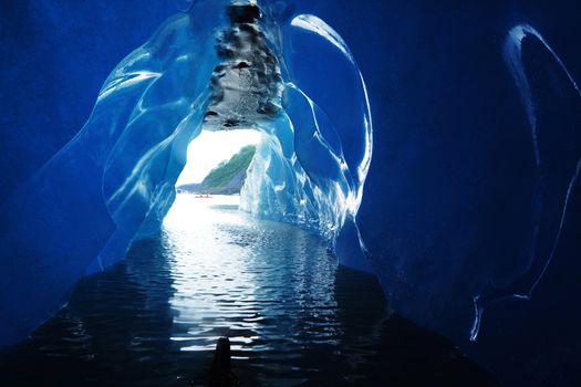ice cave in an iceberg as looking outside, from Valdez Glacier, Alaska with water drops