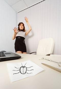 The woman was frightened drawn cockroach in the office