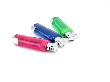 Three color lighters over white