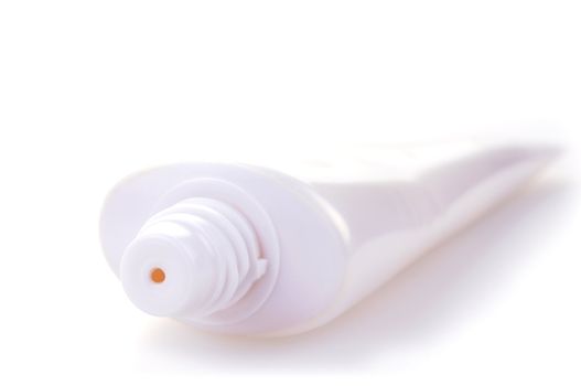 White tube of cream or other cosmetics in high key on white background