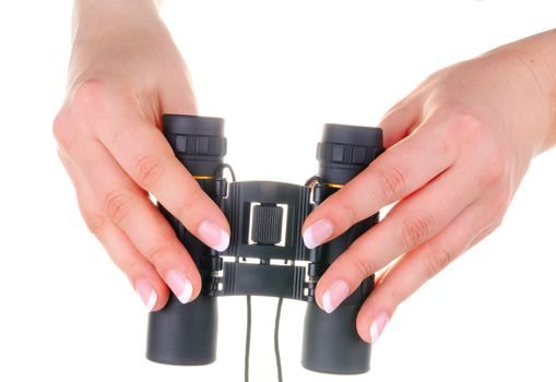 Black binoculars in female hands on white background