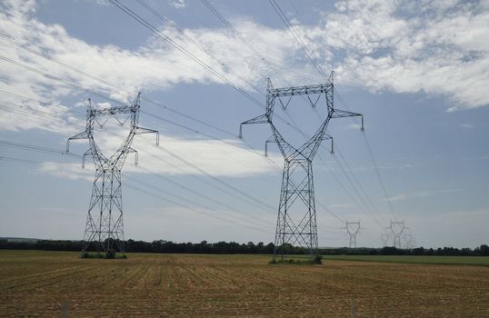 Big Electric Pylons in the Countryside with a blue sky