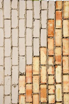 Wall made of red and white brick. Architectural decision.