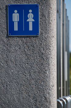 Modern unisex public toilets - sign with doors in a row