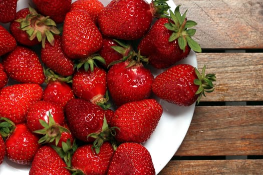 a plate of fresh strawberries