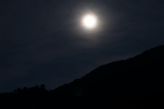 full moon rising over the mountains at Lake Como, Italy