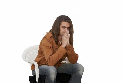 Young sexy Nice guy with long hair sitting in chair thinking