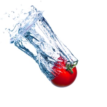 Red Tomato Falls under Water with a Splash, isolated