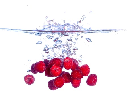 Red Raspberries Falls under Water with a Splash, isolated
