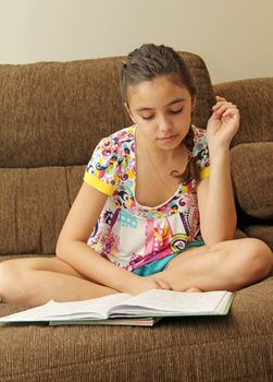 Young beautiful girl studding over a sofa