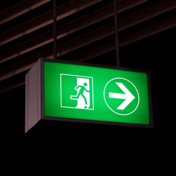 Emergency exit sign in modern offices inside an industrial plant