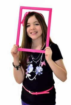 Girl with her face framed by a pink picture frame
