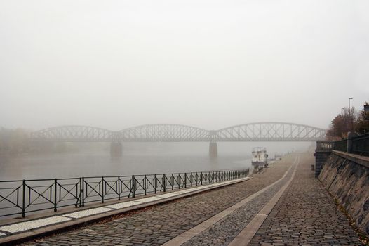 Prague railway bridge in early morning fog