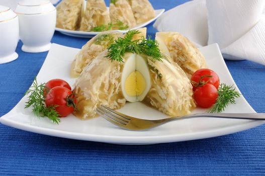 Jellied chicken decorated with egg and dill in the context of