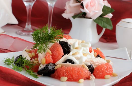 Salad of grapefruit and prunes with chicken, covered with pine nut yogurt