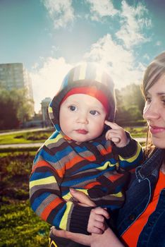 Happy mother with son in spring park.