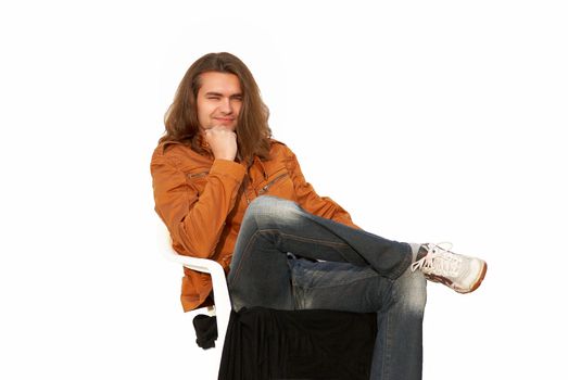Young sexy Nice guy with long hair sitting in chair thinking