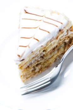 Slice of almond cake on white background