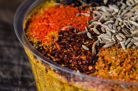 Close up Georgia spice mix on dark wooden table.