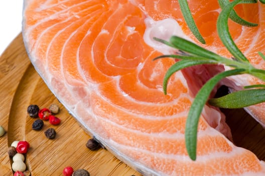 Salmon steak on a wooden board close up