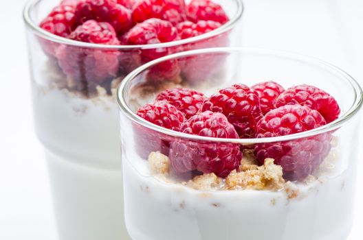 Yogurt with raspberries close up