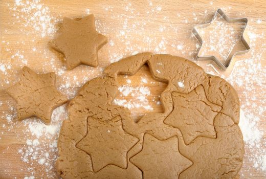 dough and cookie cutter on a wooden background