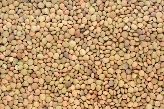 background of brown small dry raw lentils