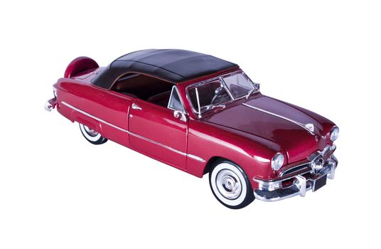 Classic red car with polished chrome trim, on a white background