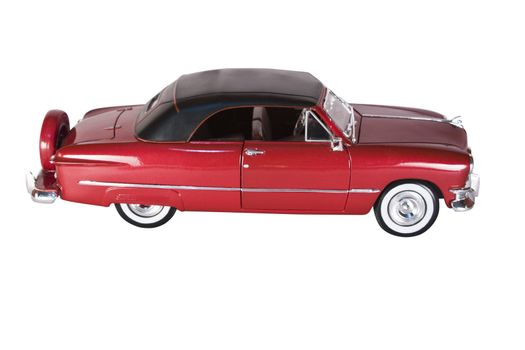 Classic red car with polished chrome trim, on a white background