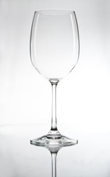 Empty glass with reflexion on white background
