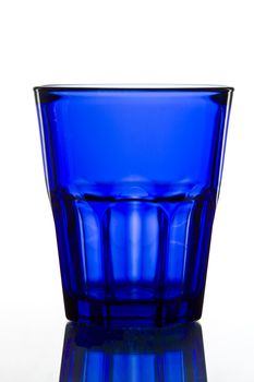 dark blue Glass on white background with reflection.
