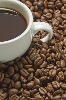 Coffee Beans and cut of black coffee, with copy space.