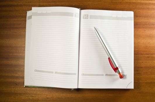 an open notebook with pen