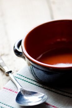 Empty bowl and spoon on the table close up