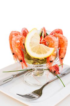 Shrimp cocktail with lemon on glass bowl close up