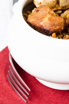 Rice and meat in a white bowl close up