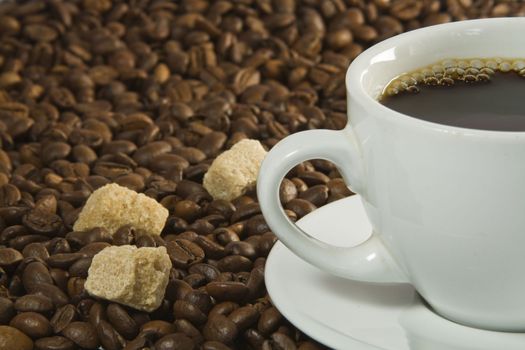 Coffee Cup and sugar with Coffee Beans background