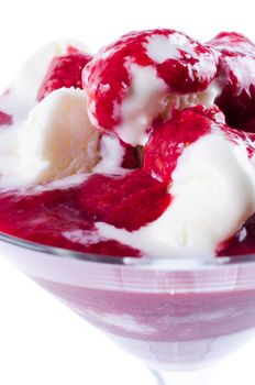 Ice cream and jam in glass isolated close up