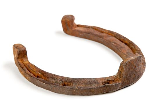 One old rusty horseshoe on a white background