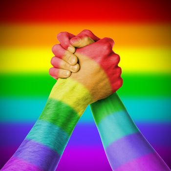 Man and woman in arm wrestlin, white background, rainbow flag pattern