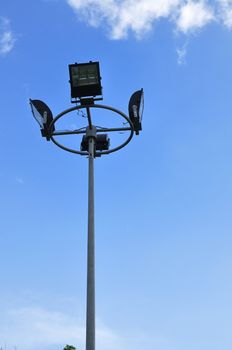 Spotlight steel poles in stadium and blue sky