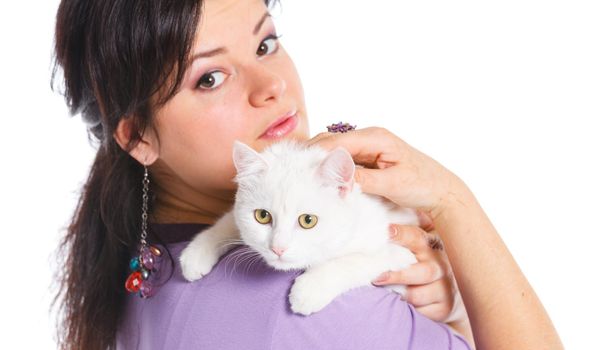 Young pretty woman hold her lovely white cat. Isolated on a white background