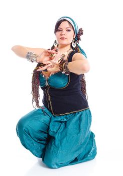 Oriental dancer in blue costume over white background