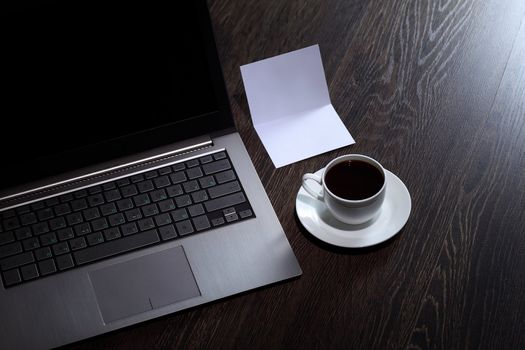 White cup with black coffee at business workplace